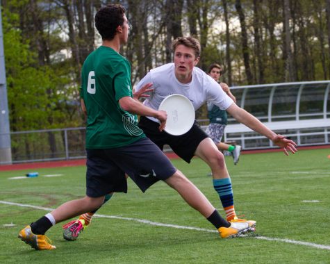 Burlington High School senior Matt Boisvert wrestles for the Frisbee in a game against Vermont Commons School in April 2016. | Photo: Jake Bucci/Register