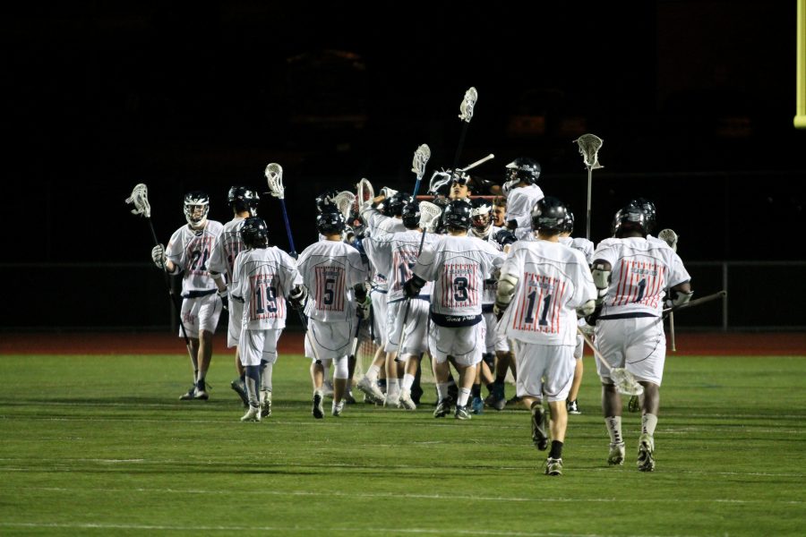 The Burlington High School boys lacrosse team celebrates after a win last season. | Photo: OREAD
