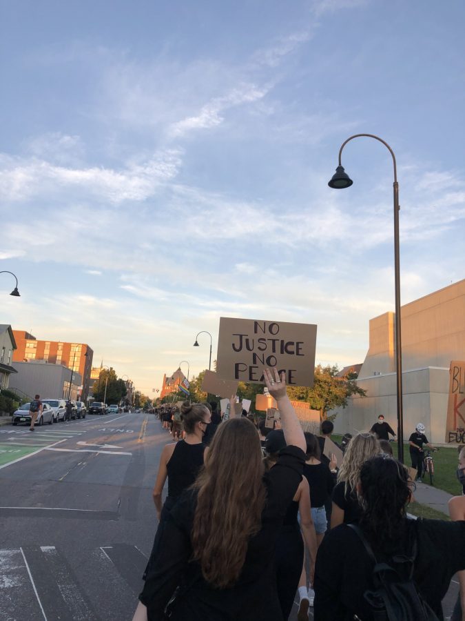 Protestors clothed in black march down Burlingtons Pearl Street on September 3, 2020. 
Photo: Anna Huener 