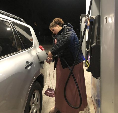 Jinny Diop putting gas in her car. Photo: Preity Mangar