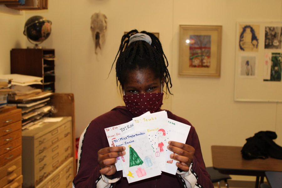 Eunice holding up some of the more than 50 thank you and holiday cards she created.