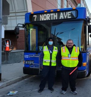 Von Hermann (left) and Austin (right) standing  
in front of the #7 North Avenue bus at its 
new, 3:30 p.m., pick up location.