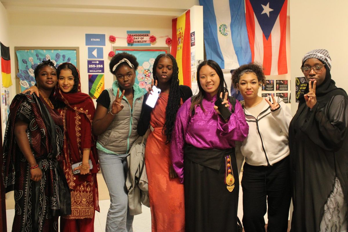Students celebrating Culture Day take a group photo in front of the German/Spanish room. 
