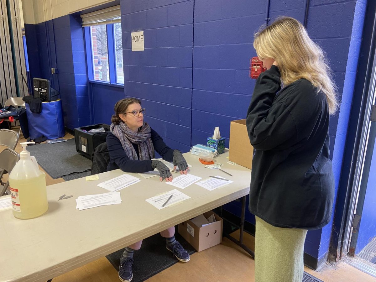 A Poll Worker assists a voter on Town Meeting Day (03/05)