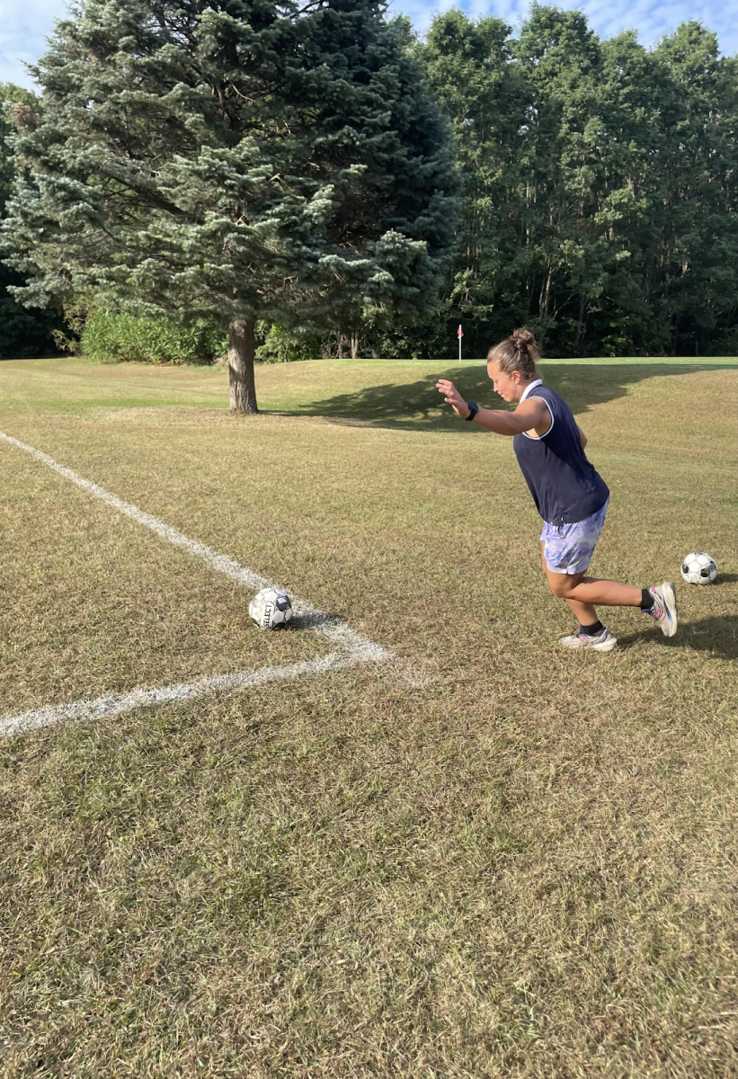 Soccer coach and PE teacher Katlyn Mastrantone demonstrates a corner kick. 