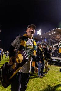 UVM Men's Soccer Head Coach Rob Dow holding the NCAA National Championship trophy after the Catamount's historic win. 