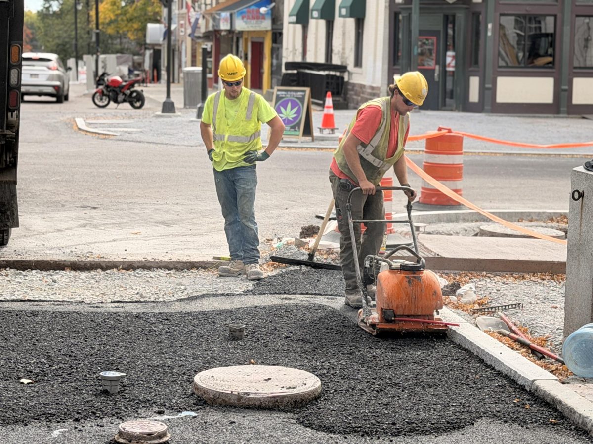 Construction workers by Church Street laying asphalt for new bike lane.