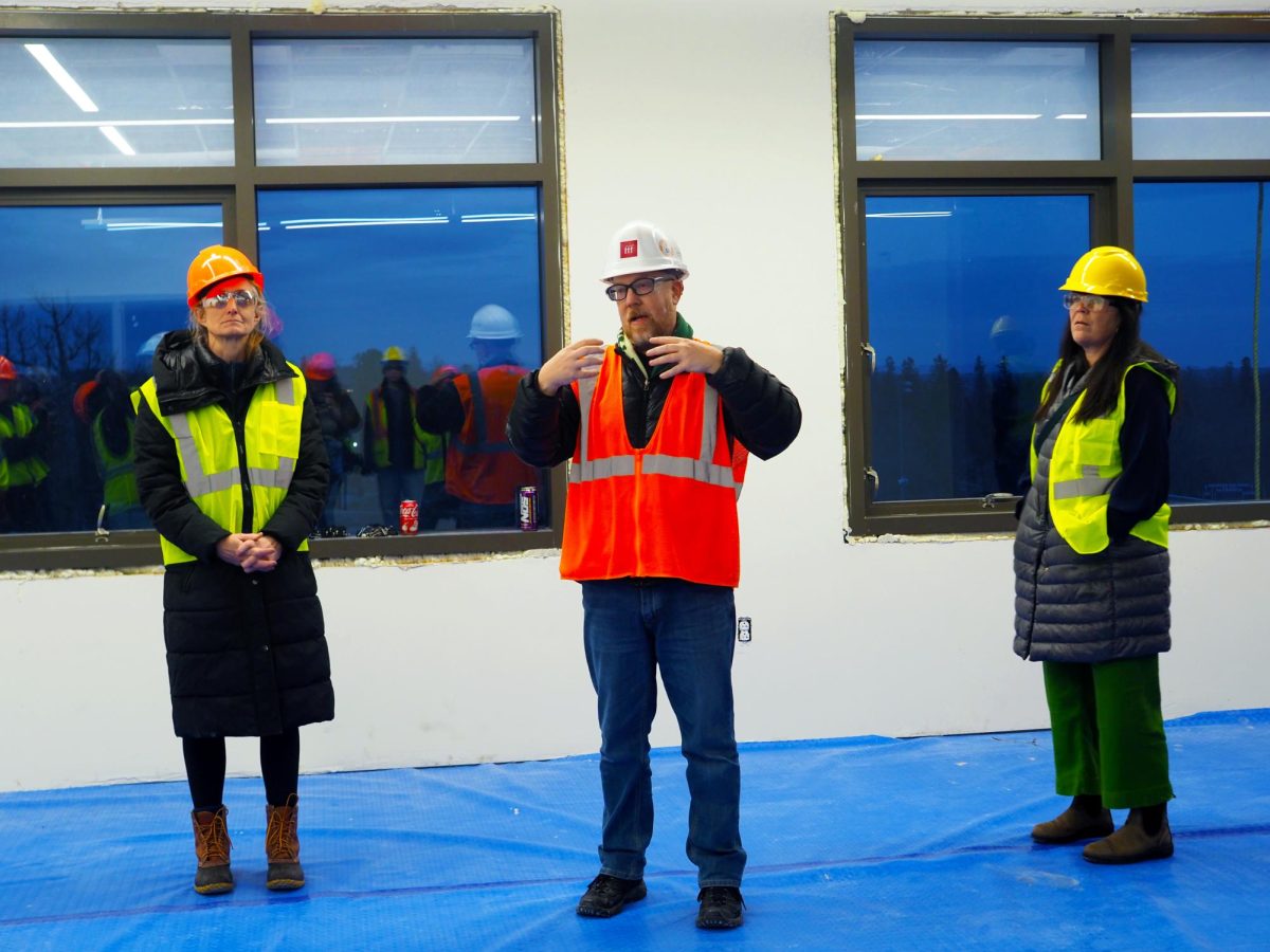 A tour guide shows us how the windows in the new BHS open and close enough to let the breeze in without being a safety hazard. 