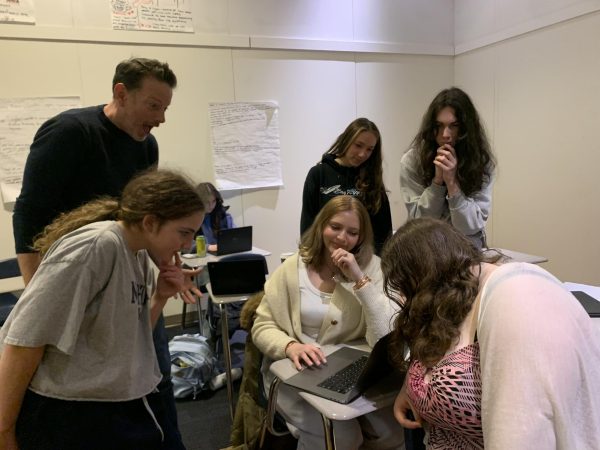 The Register Staff discussing design choices in the last edition of the print paper.